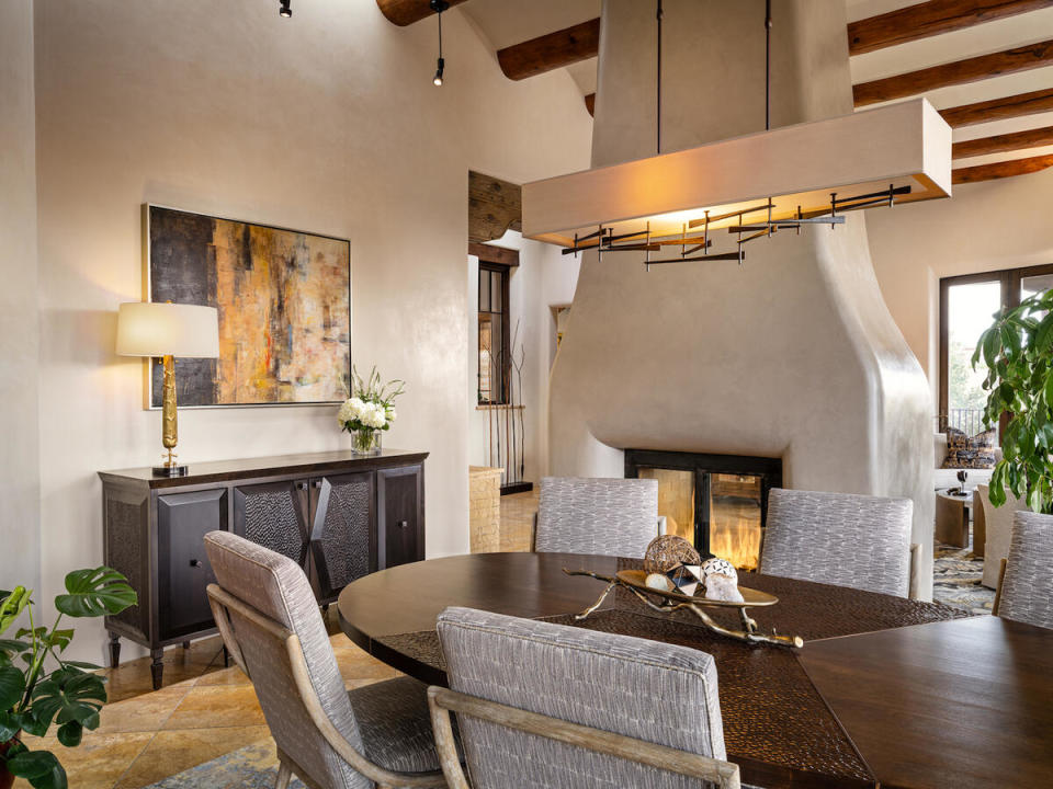 A centralized adobe fireplace deftly divides living and dining spaces