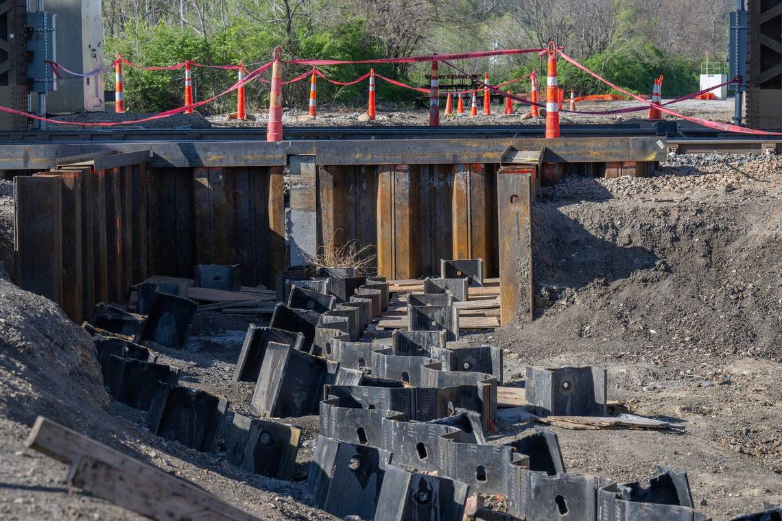 Steel H-piles used for floodwalls are gathered alongside a ditch at a Central Industrial District construction site.