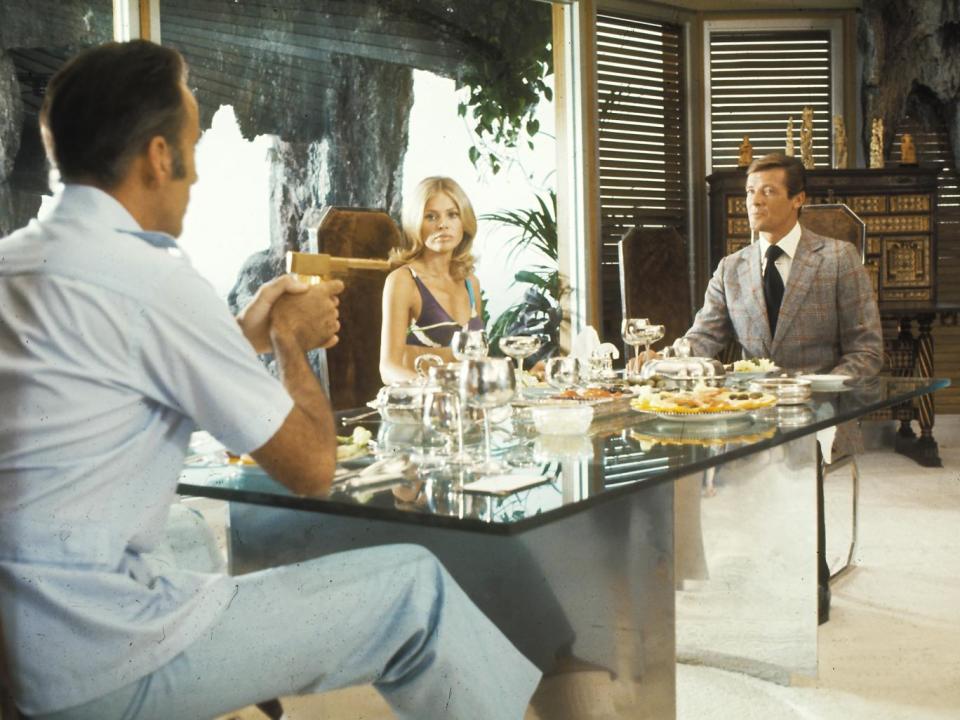 Moore as Bond (right) in ‘The Man with the Golden Gun’ with Christopher Lee and Britt Ekland (Rex)