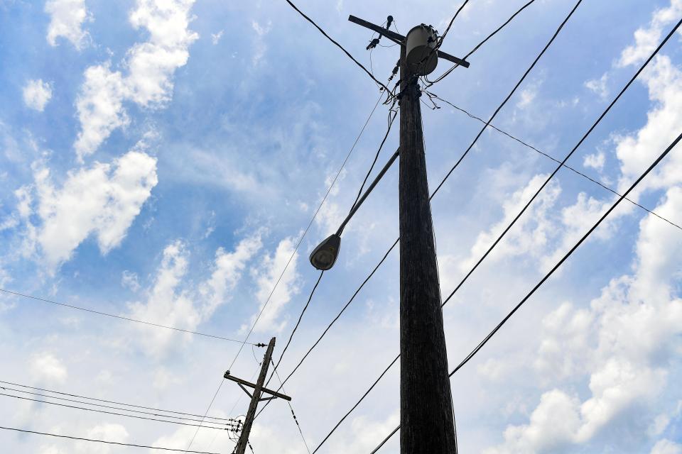 Power lines stretch between houses on Thursday, June 25, in the Whittier neighborhood in Sioux Falls.