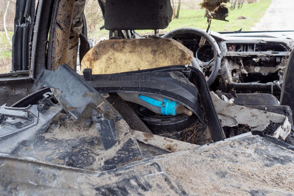 A child's bottle is left in the back of a destroyed car, left after fierce fighting between Russian and Ukrainian forces in Havronshchyna. (Mo Abbas / NBC News)