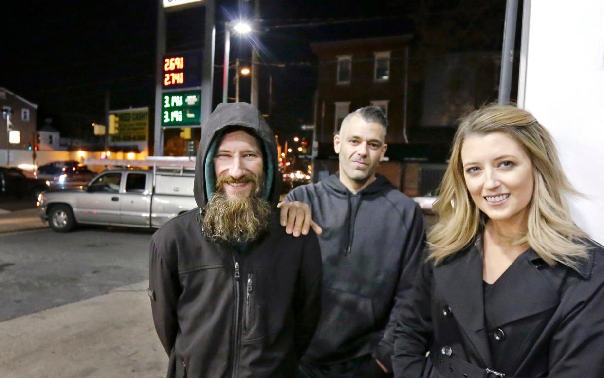 Johnny Bobbitt, left, Kate McClure, right, and McClure's boyfriend Mark D'Amico pose at a CITGO station in Philadelphia - The Philadelphia Inquirer