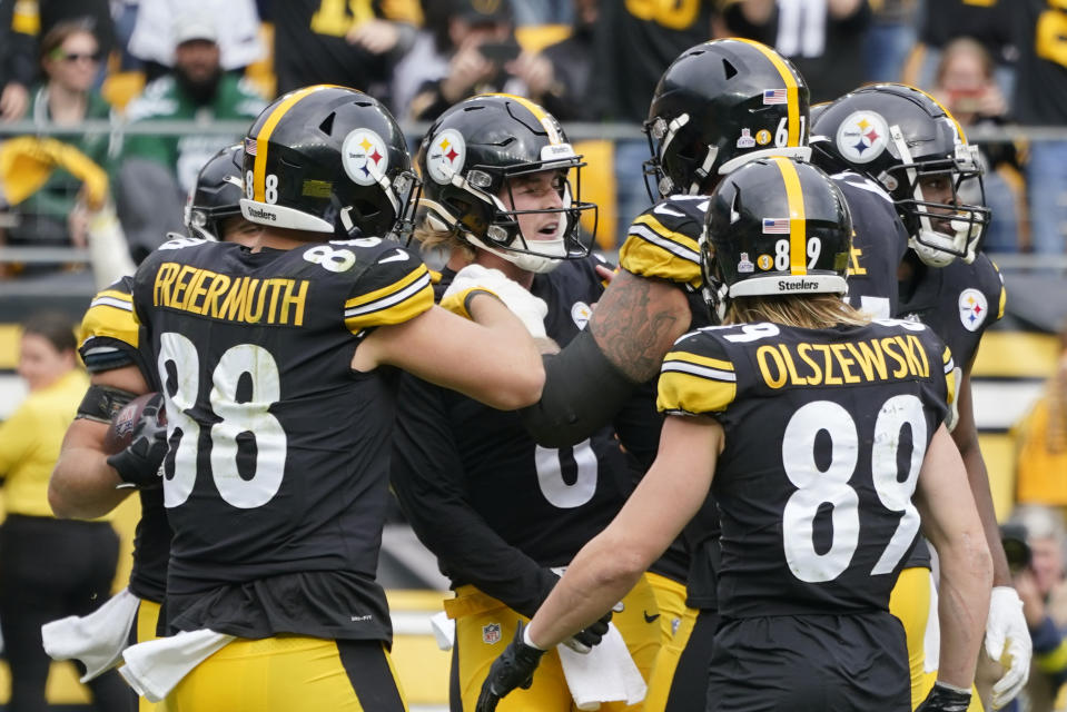 Pittsburgh Steelers quarterback Kenny Pickett (8), center, celebrates with teammates after scoring a touchdown against the New York Jets during the second half of an NFL football game, Sunday, Oct. 2, 2022, in Pittsburgh. (AP Photo/Gene J. Puskar)