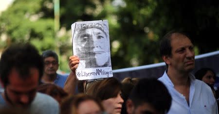 A woman holds up a portrait of Milagro Sala, the leader of the Tupac Amaru social welfare group, as supporters hear Sala's trial in San Salvador de Jujuy, with on charges ranging from intimidation to corruption, on a radio outside a Justice building in Buenos Aires, Argentina, December 28, 2016. REUTERS/Marcos Brindicci