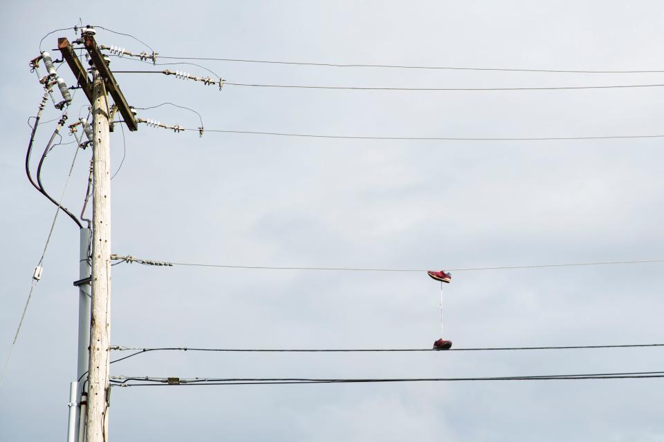 A pair of shoes dangle from utility lines in the 500 block of Lancaster Drive NE on Feb. 19.