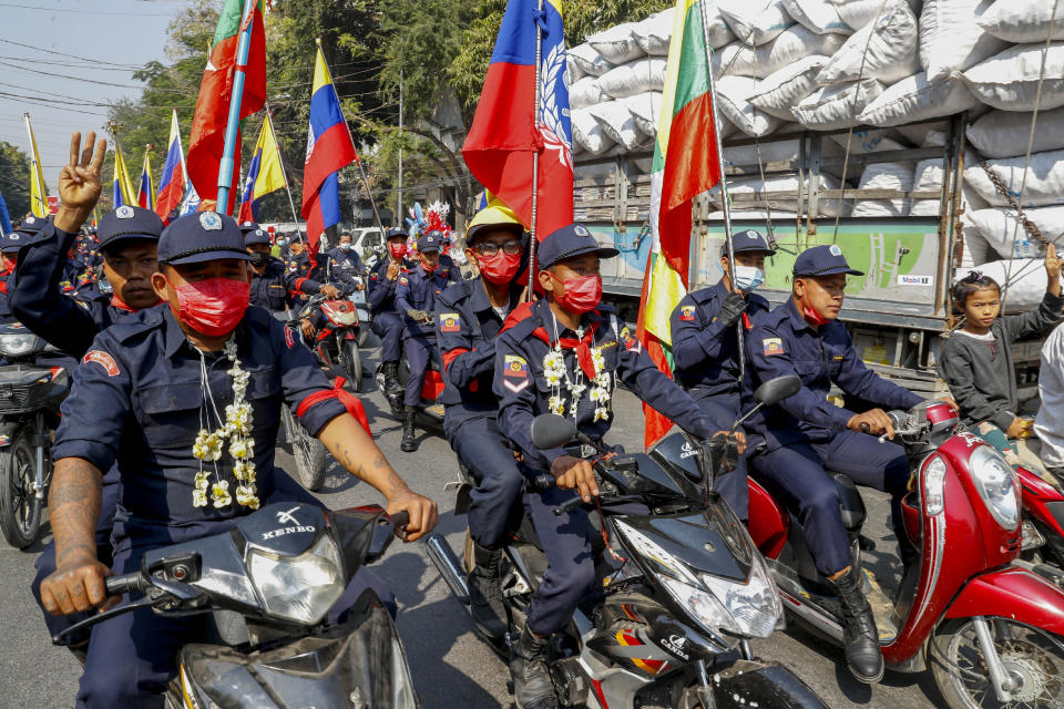 Firefighters lead a march against the military coup on motorbikes in Mandalay, Myanmar, Friday, Feb. 12, 2021. Myanmar's coup leader used the country's Union Day holiday on Friday to call on people to work with the military if they want democracy, a request likely to be met with derision by protesters who are pushing for the release from detention of their country's elected leaders. (AP Photo)