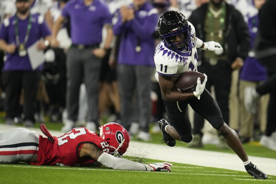 TCU 's Derius Davis (11) runs past Georgia 's Javon Bullard (22).