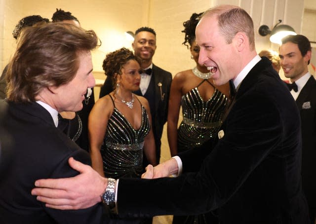 The Prince of Wales, shares a joke with Tom Cruise at the charity gala dinner 