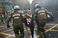 <p>A student is detained by police after throwing an object at them during a protest march demanding the government overhaul the education funding system that would include canceling their student loan debt, in Santiago, Chile, May 9, 2017. Some students stay in debt for up to 20 years after completing their studies. (AP Photo/Esteban Felix) </p>