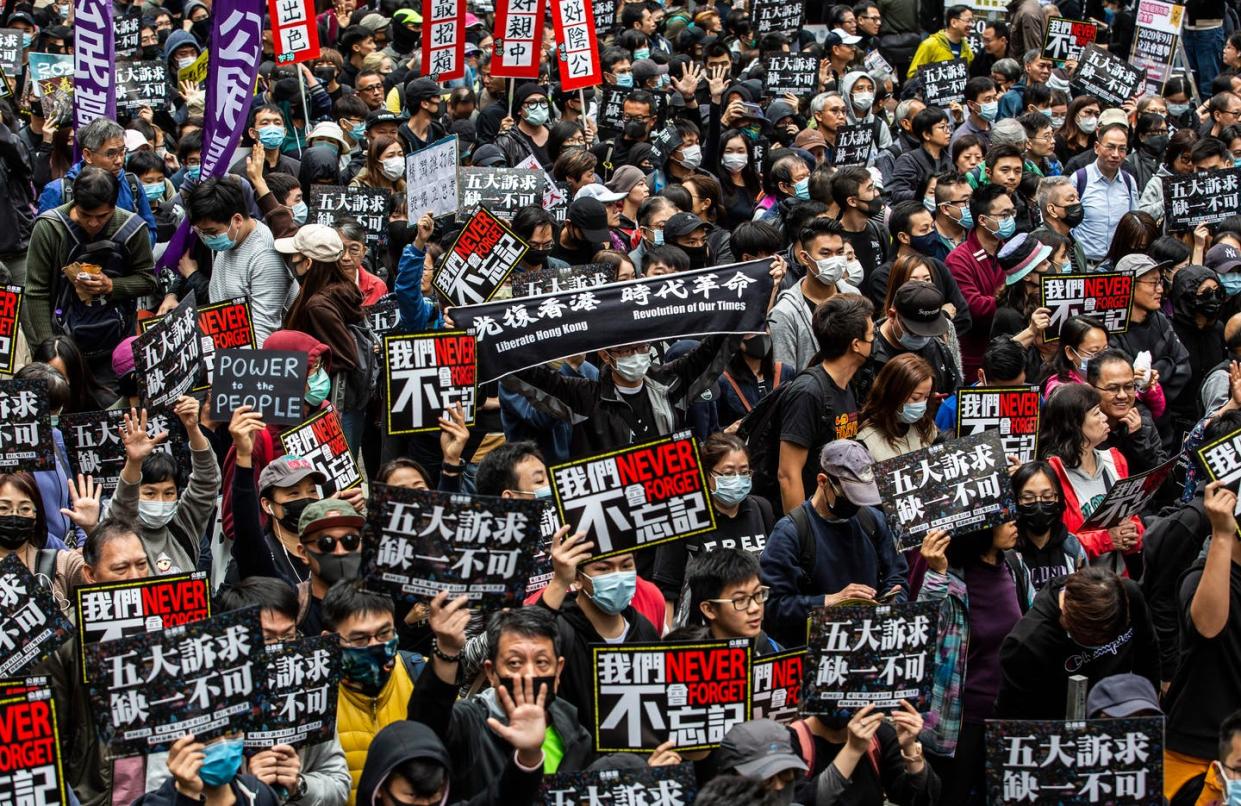 <span class="caption">Pro-democracy protesters take part in massive rally to usher in the new year.</span> <span class="attribution"><a class="link " href="https://www.gettyimages.com/detail/news-photo/people-take-part-in-a-pro-democracy-march-in-hong-kong-on-news-photo/1191131347?adppopup=true" rel="nofollow noopener" target="_blank" data-ylk="slk:Isaac Lawrence/AFP via Getty Images;elm:context_link;itc:0;sec:content-canvas">Isaac Lawrence/AFP via Getty Images</a></span>