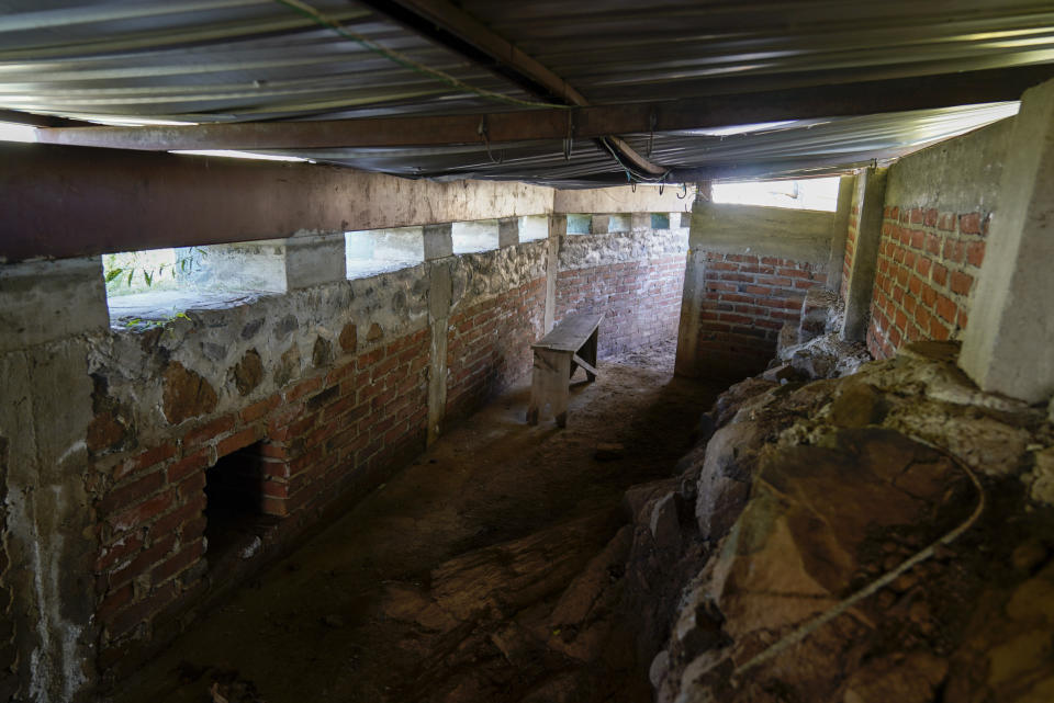 A view of a “self-defense” squad bunker built of concrete, steel beams and brick, topped with more concrete, on a hilltop near Tepalcatepec in the Michoacan state of Mexico, Thursday, Oct. 28, 2021. Self-defense members can approach the bunker, known as “Achicumbo,” via meter-deep trenches to avoid sniper fire. (AP Photo/Eduardo Verdugo)