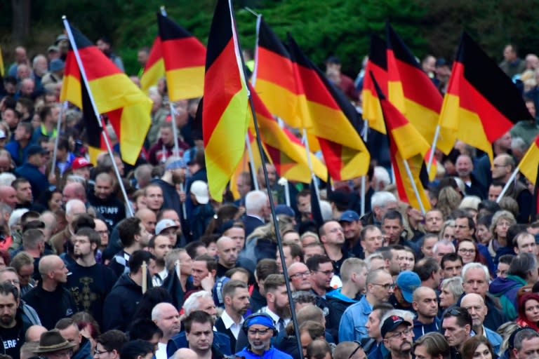 Demonstrators brandish German flags at a rally organised by the right-wing populist "Pro Chemnitz" movement, the far-right Alternative for Germany (AfD) party and the anti-Islam Pegida movement in Chemnitz, scene of attacks by a racist mob in recent days