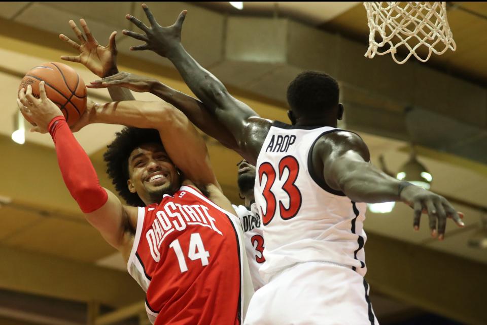 Ohio State forward Justice Sueing (14) grabs a rebound over San Diego State forward Aguek Arop (33) during the first half of an NCAA college basketball game, Monday, Nov. 21, 2022, in Lahaina, Hawaii. (AP Photo/Marco Garcia)