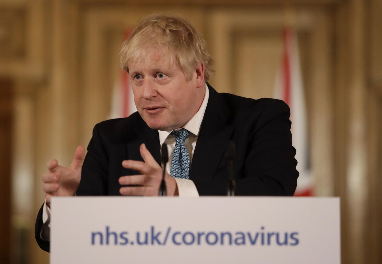 British Prime Minister Boris Johnson gestures as he gives a press conference about the ongoing situation with the COVID-19 coronavirus outbreak inside 10 Downing Street in London, Tuesday, March 17, 2020. For most people, the new coronavirus causes only mild or moderate symptoms, such as fever and cough. For some, especially older adults and people with existing health problems, it can cause more severe illness, including pneumonia. (AP Photo/Matt Dunham, Pool)