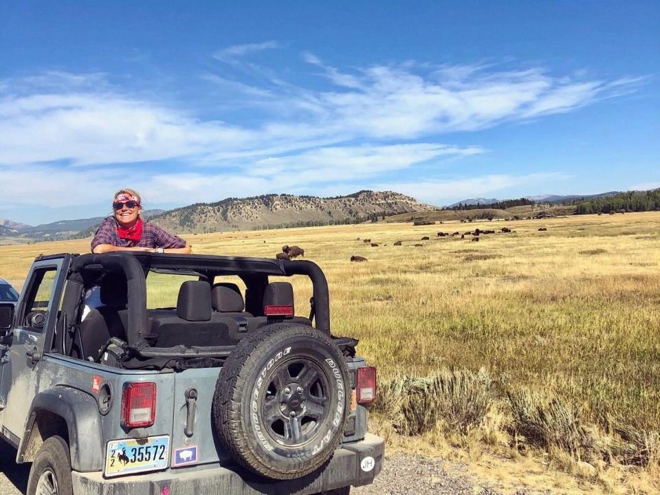 Katherine Parker-Maygar on a jeep smiling in grand teton national park