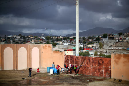 Migrants, part of a caravan of thousands from Central America trying to reach the United States, rest after moving to a new temporary shelter in Tijuana, Mexico, November 30, 2018. REUTERS/Hannah McKay