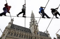 Tightrope walkers perform on Brussels's Grand Place during an event marking the 30th birthday of the circus school of Brussels November 6, 2011. REUTERS/Francois Lenoir