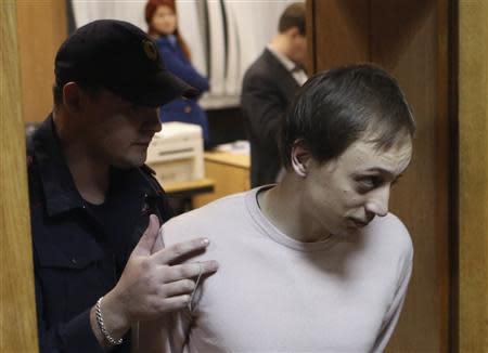 Bolshoi Theatre dancer Pavel Dmitrichenko (R), who is on trial for ordering an acid attack on the artistic director of Russia's Bolshoi ballet Sergei Filin, is escorted out of a court room in Moscow, November 6, 2013. REUTERS/Sergei Karpukhin