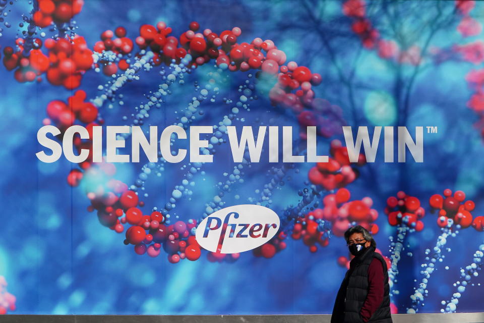 A person walks past the Pfizer Headquarters building in the Manhattan borough of New York City, New York, U.S., December 7, 2020. Picture taken December 7, 2020. REUTERS/Carlo Allegri