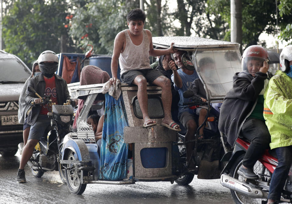 In this Jan. 12, 2020, photo, residents evacuate as Taal Volcano erupts in Tagaytay, Cavite province, outside Manila, Philippines. (AP Photo/Aaron Favila)