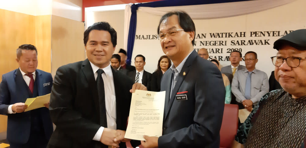 Roland Engan, a parliamentary coordinator for Baram, receives his appointment letter from Works Minister Baru Bian February 21, 2020. — Picture by Sulok Tawie