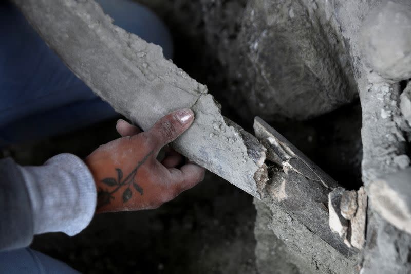 A worker of Mexico's National Institute of Anthropology and History (INAH) works at a site where more than 100 mammoth skeletons have been identified, along with a mix of other ice age mammals, in Zumpango