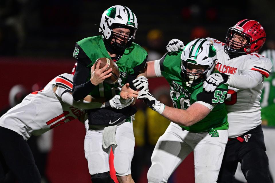 West Branch's Dru DeShields is hit by Jefferson's Luke Funtash during the second half of their playoff game, Saturday night at Bo Rein Stadium in Niles.