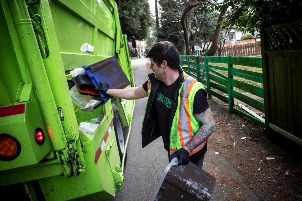 Clay Danyluk, with GFL Environmental Waste management company is pictured on his route in Vancouver, British Columbia on Friday, April 3, 2020. 