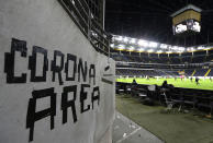 Eintracht fans have taped letters at a wall of the stadium during a Europa League round of 16, 1st leg soccer match between Eintracht Frankfurt and FC Basel in Frankfurt, Germany, Thursday, March 12, 2020. The match was played in an empty stadium because of the coronavirus outbreak. For most people, the new coronavirus causes only mild or moderate symptoms, such as fever and cough. For some, especially older adults and people with existing health problems, it can cause more severe illness, including pneumonia. (AP Photo/Michael Probst)