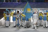 Kazakhstan's flag-bearer Yerdos Akhmadiyev leads his country's contingent during the opening ceremony of the 2014 Sochi Winter Olympics, February 7, 2014. REUTERS/Phil Noble (RUSSIA - Tags: OLYMPICS SPORT)