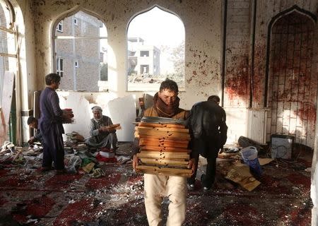 ATTENTION EDITORS - VISUAL COVERAGE OF SCENES OF INJURY OR DEATH Afghan men inspect inside a Shi'ite Muslim mosque after last night attack in Kabul, Afghanistan October 21, 2017. REUTERS/Omar Sobhani