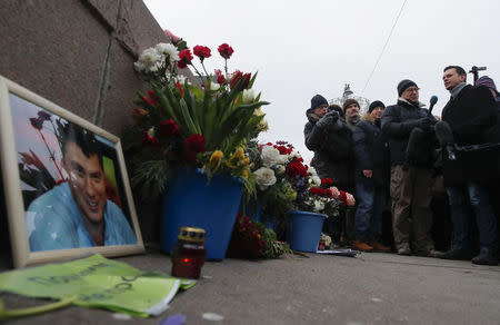 Russian opposition figure Ilya Yashin (R) visits the site of the assassination of opposition leader Boris Nemtsov while marking the third anniversary of Nemtsov's death in central Moscow, Russia February 25, 2018. REUTERS/Maxim Shemetov