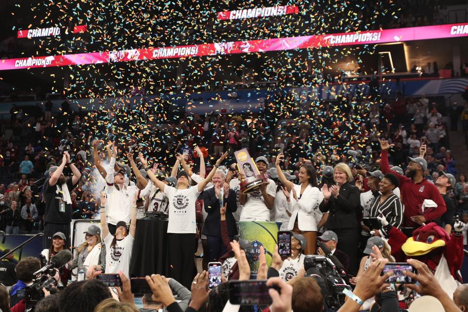 South Carolina head coach Dawn Staley and players celebrate with the trophy after defeating UConn to win the Final Four championship game of the women's college basketball NCAA Tournament at Target Center.
