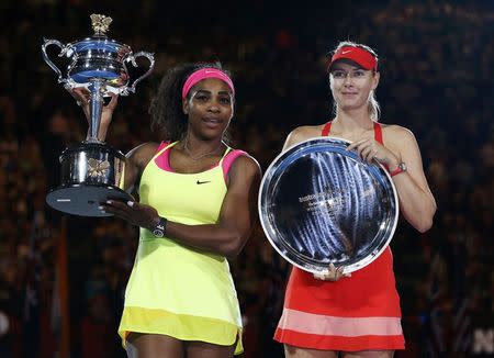 Serena Williams (L) of the U.S. and Maria Sharapova of Russia pose with their trophies after their women's singles final match at the Australian Open 2015 tennis tournament in Melbourne January 31, 2015. REUTERS/Issei Kato