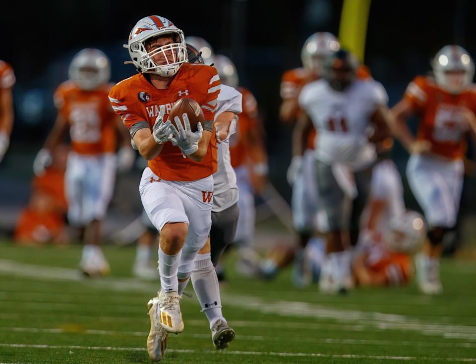 Westwood wide receiver Grant Jaeger, catching a pass against Hutto in 2021, will help lead the Warriors' offense this season after totaling 76 catches and 605 yards last year.