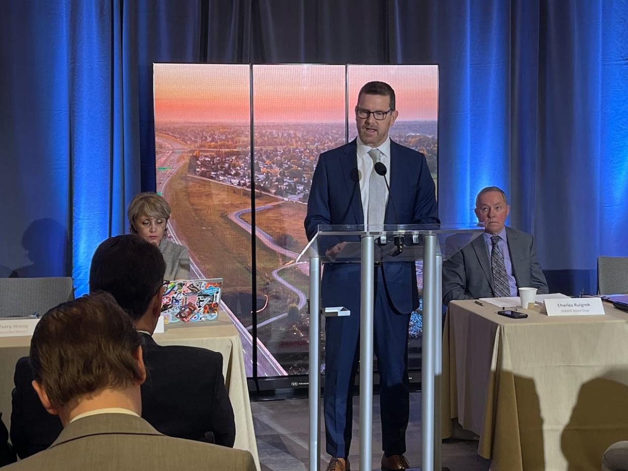 Figures released Friday show Enmax CEO Mark Poweska, centre, received over $3 million in compensation from the city-owned utility in 2023. He is shown speaking at the utility's annual general meeting on Friday with Calgary Mayor Jyoti Gondek seated on the left, and Enmax board chair Charles Ruigrok on the right. (Scott Dippel/CBC - image credit)