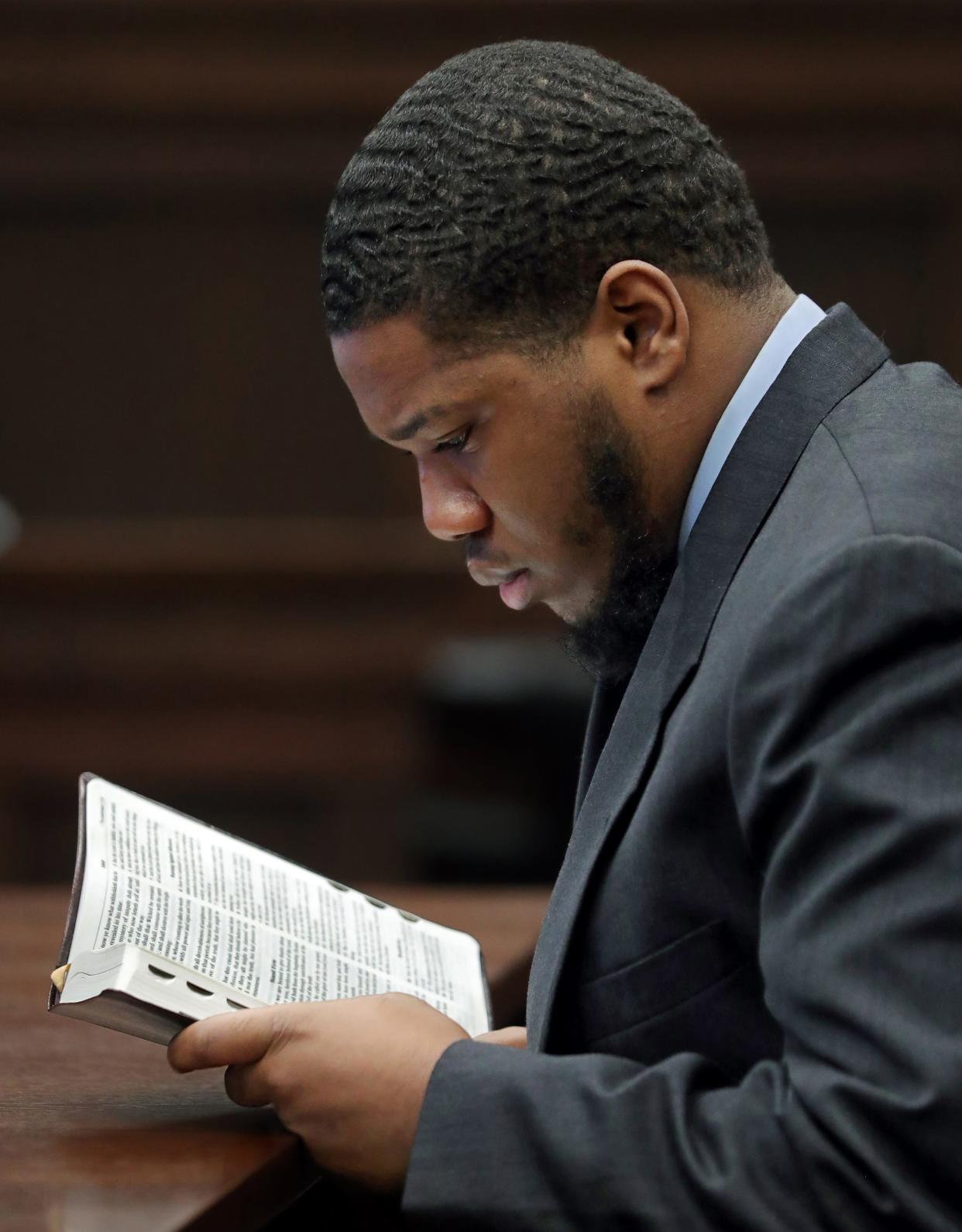 Defendant Thomas Ellis reads scripture Tuesday as he awaits the jury’s verdict on his charges related to the shooting death of Dominic Gray in Judge Susan Baker Ross’ courtroom at the Summit County Courthouse in Akron.