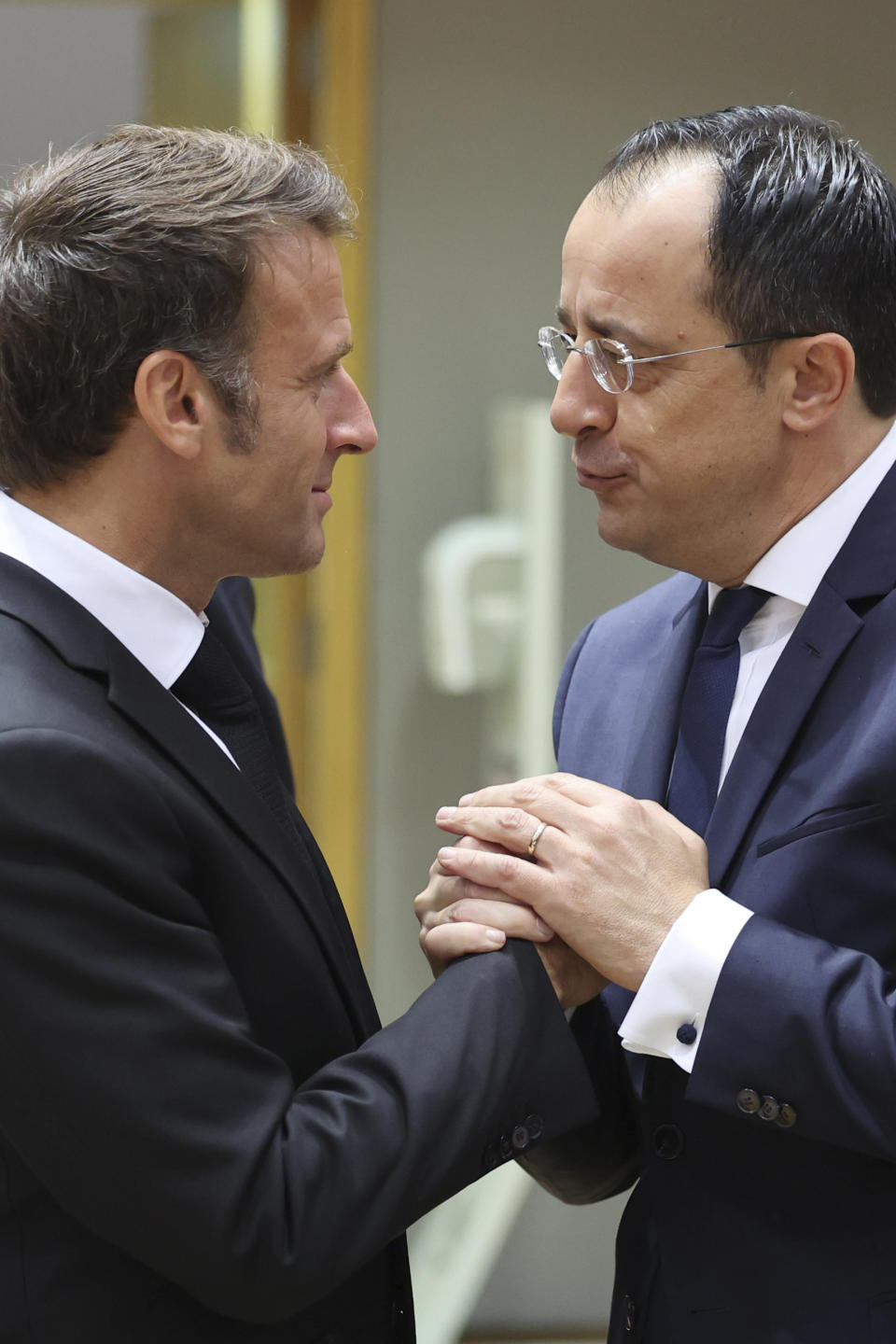 France's President Emmanuel Macron, left, speaks with Cypriot President Nikos Christodoulides during a round table meeting at an EU summit in Brussels, Thursday, June 29, 2023. Attendance by NATO chief Jens Stoltenberg and a video address by Ukraine President Volodymyr Zelenskyy at Thursday's European Union summit will underscore the importance that the 27 EU leaders attach to protecting their eastern flank from Russian aggression and beefing up Ukraine's defense capabilities.(AP Photo/Geert Vanden Wijngaert)