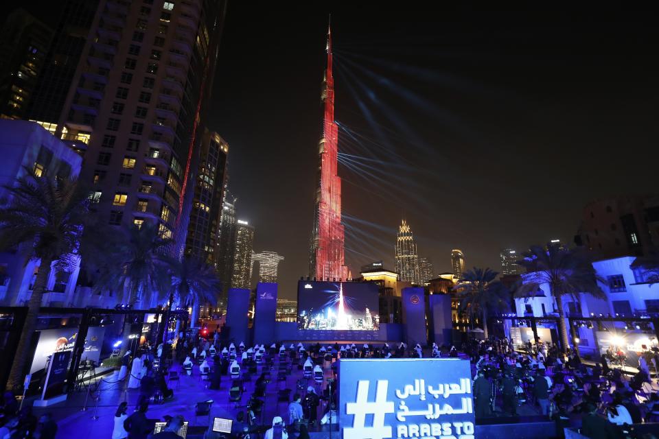 The world tallest tower, Burj Khalifa is lit up with a laser show to celebrate the Hope Probe entering Mars orbit as a part of the Emirates Mars mission, in Dubai, United Arab Emirates, Tuesday, Feb. 9, 2021. The spacecraft from the UAE swung into orbit around Mars in a triumph for the Arab world’s first interplanetary mission. It is the first of three robotic explorers arriving at the red planet over the next week and a half. (AP Photo/Kamran Jebreili)