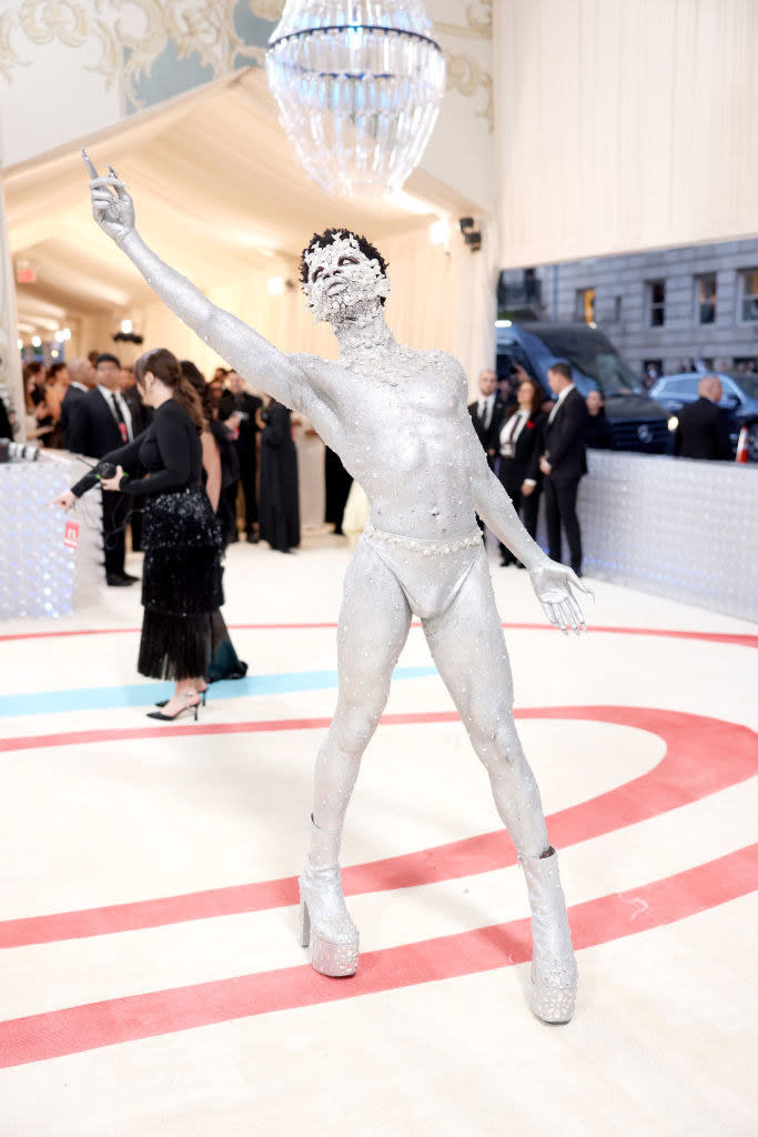 Lil Nas X attends The 2023 Met Gala in glittering body paint