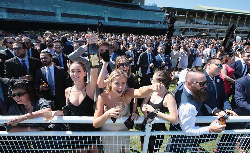 <p>Pictured: Punters brave wild weather as Melbourne Cup festivities get underway</p>