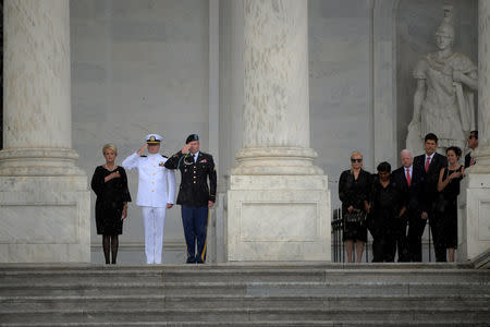 Cindy McCain, left, with family, pays her respects as the casket of U.S. Capitol is carried up the steps of the U.S. Capitol in Washington D.C., U.S., August 31, 2018. John McDonnell/Pool via REUTERS