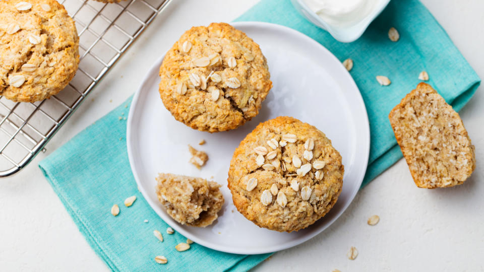 Whole wheat muffins on a white plate with a blue napkin