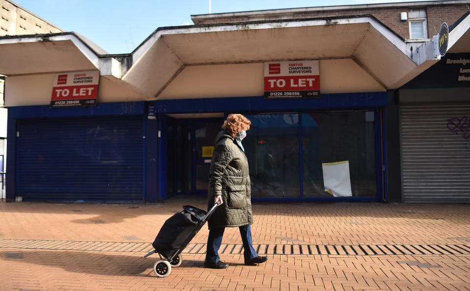 BARNSLEY-ENGLAND - FEBRUARY 27: A lady walks past a closed shop which is To Let on February 27, 2021 in Barnsley, England . (Photo by Nathan Stirk/Getty Images) (Photo by Nathan Stirk/Getty Images)