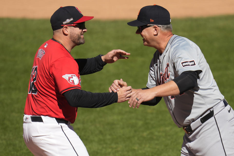 Cleveland Guardians manager Stephen Vogt, left, and Detroit Tigers manager A.J. Hinch, right, greet each other before Game 1 of baseball's American League Division Series against the Detroit Tigers, Saturday, Oct. 5, 2024, in Cleveland. (AP Photo/Sue Ogrocki)