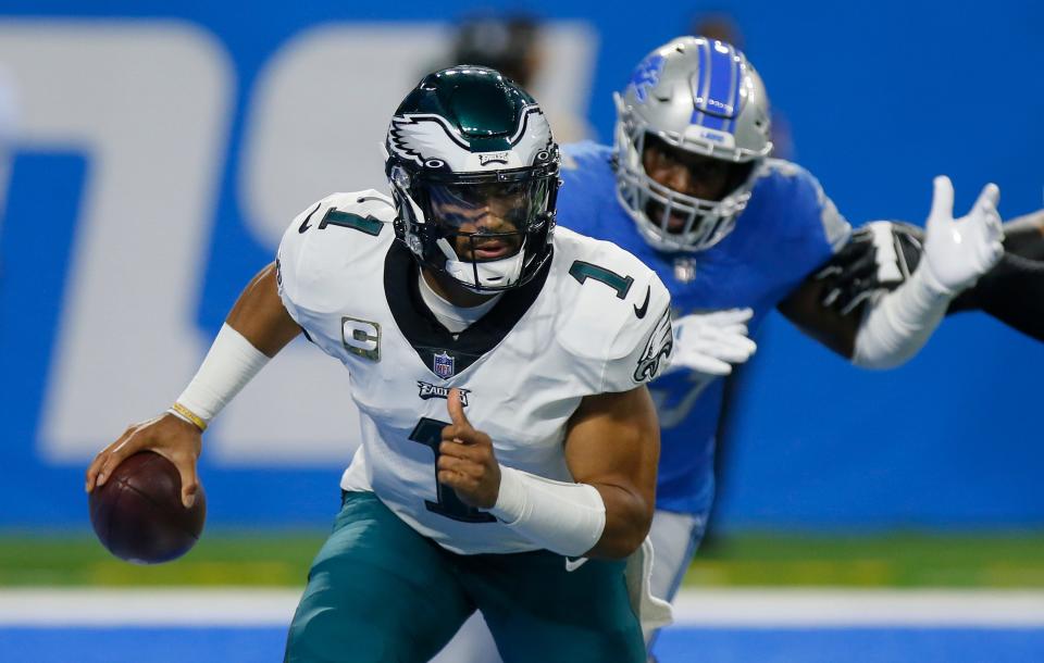 Philadelphia Eagles quarterback Jalen Hurts (1) is pursued by Detroit Lions outside linebacker Charles Harris (53) during the first half of an NFL football game, Sunday, Oct. 31, 2021, in Detroit.