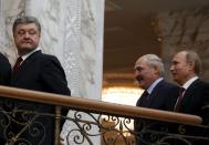 Ukraininan President Petro Poroshenko (L) looks back, followed by Belarussian President Alexander Lukashenko and Russian President Vladimir Putin (R) after a meeting in Minsk, in this February 11, 2015 file photo. REUTERS/Grigory Dukor/Files