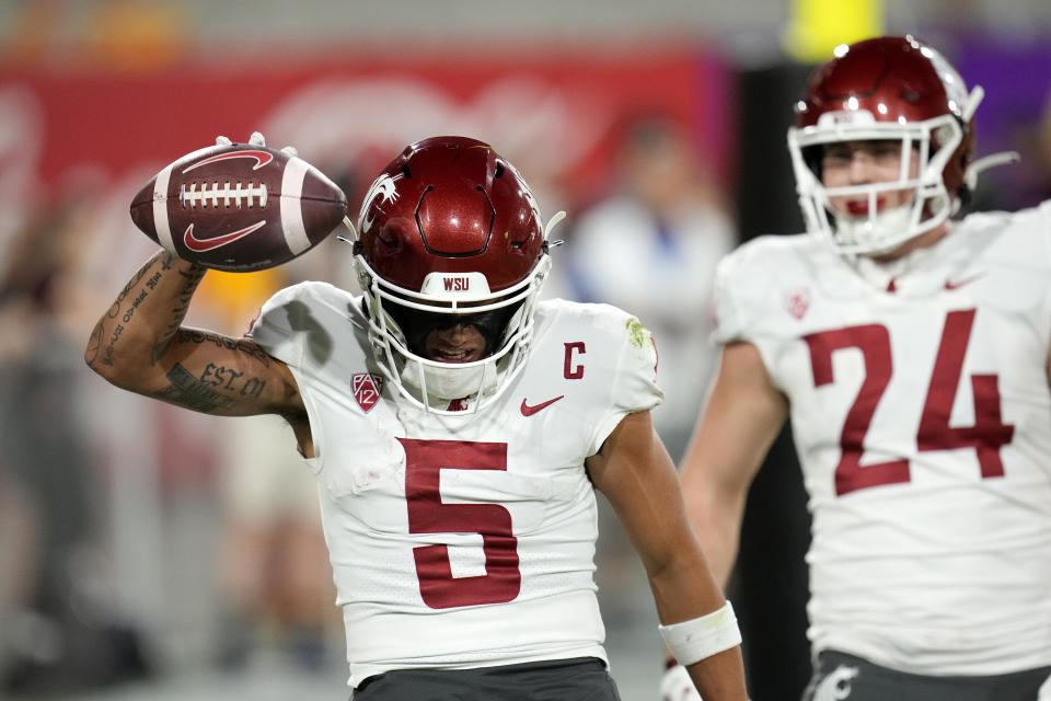 Washington State wide receiver Lincoln Victor (5) celebrates after his touchdown catch against Arizona State as Washington State tight end Cooper Mathers (24) looks on during the first half of an NCAA college football game Saturday, Oct. 28, 2023, in Tempe, Ariz. (AP Photo/Ross D. Franklin)