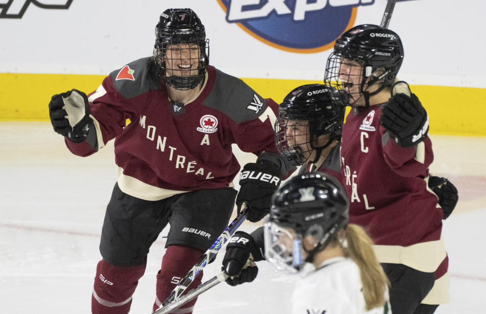 Montreal's Kristin O'Neill, center, celebrates after her goal against Boston with teammates Laura Stacey (7) and Marie-Philip Poulin (29) during second-period PWHL playoff hockey game action in Laval, Quebec, Saturday, May 11, 2024. (Christinne Muschi/The Canadian Press via AP)