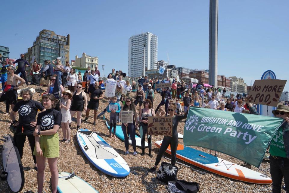 Surfers Against Sewage hold a UK-wide paddle-out protest at Brighton West Pier in East Sussex (PA)